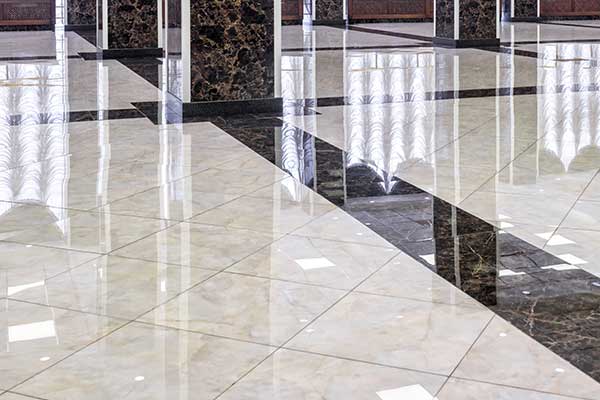 Shiny, reflective white and black tiles in a commercial lobby area